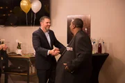 Dr. Procter and Drew smiling while shaking hands at the reveal party. Dr. Procter and Drew smiling while shaking hands at the reveal party.