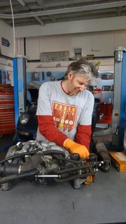 Edd China in the workshop, working on the Porsche.