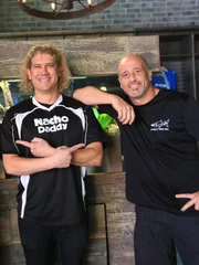 Brett and Paul pose in front of the scorpion tank.