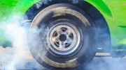 Drag racing car burns rubber off its tires in preparation for the race Drag racing car burns rubber off its tires in preparation for the race
