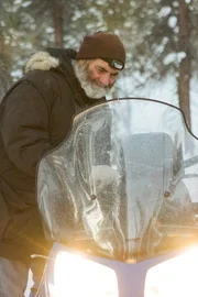 Heimo getting on a snow machine.