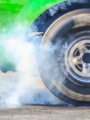 Drag racing car burns rubber off its tires in preparation for the race