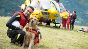 Rescue dogs with their owner by a helicopter in Italy. Rescue dogs with their owner by a helicopter in Italy.