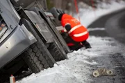 Jo Roger Bengsli checks on a 20-ton truck lying deep in a ditch.