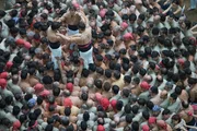 Tarragona, SPAIN - A team begins their construction of a "human tower" - this traditional Catalan competition is  held yearly in Tarragona, Spain - teams must compete to build the tallest and most complex tower.