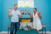 Brian and Mika Kleinschmidt pose in Gio Regazzoni's new bedroom, as seen on 100 Day Dream Home, Season 6.