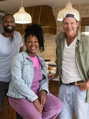 Mentor Ty Pennington (r.) poses with Steven (l.) and Ashley (m) in their winning kitchen.