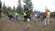 Crew filming miners talking around campfire