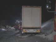A 22-ton truck carrying concrete is stuck on a narrow, winding road.