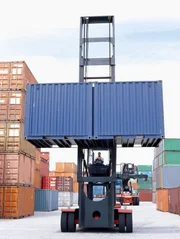 Man lifting a container with a forklift.