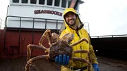 Seabrooke greenhorn Tom Monschein holding crab.