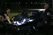 Chuck, l. checks out Dominator as he performs a few adjustments on his car.