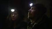 Stephen and Allyce, stand in the dark with head strap flashlights and search for a missing dog.