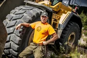 Chris Doumitt standing by a dozer.