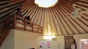 As seen on Tiny House Hunters, buyer Melanie (above) and friend Grant admire the circular structure of the yurt in Los Angeles, CA.