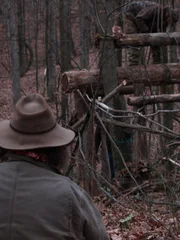 Trapper and Huckleberry looking on as Willy works on the trap outside.