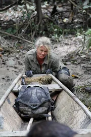 Ruth pushing boat over land. Intrepid couple Mykel and Ruth Hawke, return with more survival scenarios in the second series of Man, Woman, Wild. Stranded in remote, forbidding locations, they must work together, using their limited resources to enable them to survive for four days and nights in challenging environments. This series, Mykel and Ruth are marooned on a boat in the Bermuda triangle, dine on tarantulas and scorpions in the mountainous high desert of Southern California and have to navigate through the flooded Amazon basin. Though coping with extreme situations and conditions is second nature to former Green Beret and survival expert Mykel, living in the wild is still a very new experience for his wife, television journalist Ruth. Putting their survival skills- and their marriage- to the test, the two must find common ground, standing up to nature as husband and wife in the wildest places on Earth.