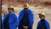 Gui Cavalcanti, Tom Johnson and Alison Wong dressed in blue capes and propeller hats.