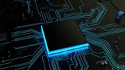 Das Bild zeigt einen Computerchip auf einer Leiterplatte (PCB) mit leuchtenden Spuren, die die elektrischen Verbindungen darstellen.