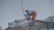 Wizard greenhorn, Caelan Colburn attaches a picking hook to a crab pot in the shipyard.