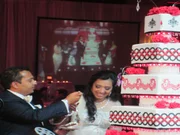 The bride and groom sample the wedding cake.