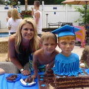 Lisa Valastro and Marco pose next to the cake.