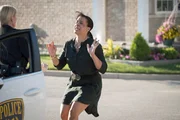 A visibly disturbed Nikki Whitehead (played by Nicole Moore) flags down a uniformed officer (played by Anna Jarmula) on this episode