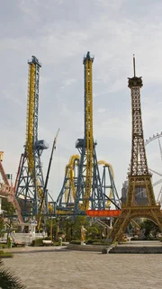 Shanghai, China: Two towers of the Giant Inverted Boomerang loom over the reproduced Eiffel Tower at the Jinjiang Action Park in Shanghai, China.