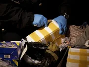 Luggage is inspected by a Customs and Border Protection officer at John F. Kennedy International Airport.