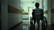 Rearview shot of a senior woman sitting in a wheelchair