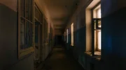 Dark creepy corridor of abandoned hospital at night. Horror concept.