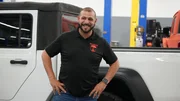 Joe talking to mechanics about the Amphibious truck build, as seen on Truck Dynasty.