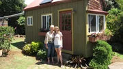 As seen on Tiny House Hunters, buyer Cyndy (L) and her daughter Hannah stand in front of this eclectic 144 sg ft bungalow in Waimea, HI.