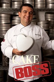 Buddy Valastro posing in front of cake pans.