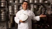 Buddy Valastro posing in front of cake pans. Buddy Valastro posing in front of cake pans.