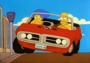 Homer macht in seinem neuen Wagen mit Marge eine riskante Spritztour.