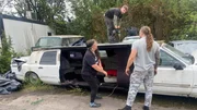 Chris Fuchs and Isabella Fuch with their son Leon Fuchs sawing up an old Cadillac Lincoln Town Car stretch limousine from the 1980s, to prepare it for the scrap baler.