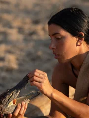 Michelle holds up the alligator head.