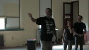 Paranormal investigators, Amy Bruni and Adam Berry, listen to Will Conkel, Farrar's Caretaker, as he points out where the Tall Shadowman likes to appear in the school's auditorium