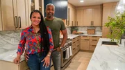 Egypt Sherrod and Mike Jackson posing in the renovated kitchen as seen on Married to Real Estate