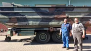 Marcus Thiel and neighbor Stefan Tonne stand in front of the Bundeswehr's decommissioned M3 boat on the grounds of Thiel Baumschinen in Neerstedt.