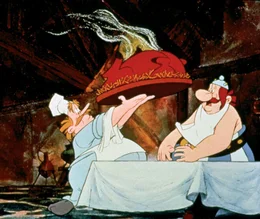 Selbst der belgische Koch Mannekenpix (li.) schafft es nicht, Obelix zu s&auml;ttigen. Damit hat Obelix auch die n&auml;chste Aufgabe bestanden.