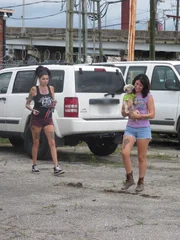 Lizzy and Tania approach the trailer with Hilda.