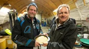 Shawn Pomrenke & Dave Young holding pan of gold together