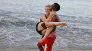 Jay carries Ashley at the beach.