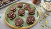 Beauty shot of Molly Yeh's Chocolate Pecan Sandwich Cookies, as seen on Girl Meets Farm, season 9.