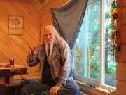 Billy Brown smiling in his house.