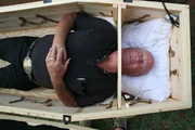 Jackie Bibby prepares for his big stunt in a coffin during the parade at the Peanut Festival.