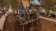 The rustic domicile with a spiral staircase and native plants.