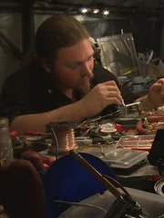 Noah Brown tinkering with his newest invention, a bear alarm.